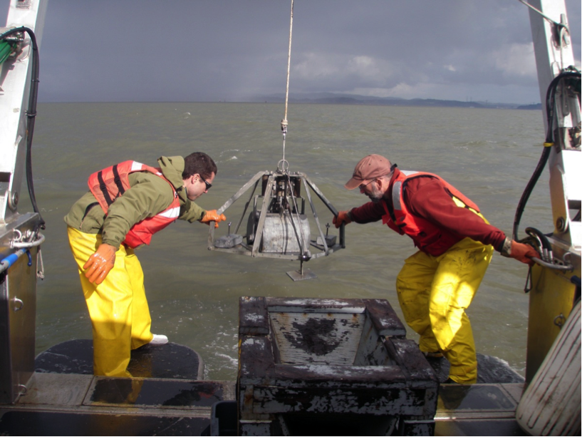 Jeff Hansen and Daniel Hoover send a “sand grab” into San Pablo Bay to collect sand samples. (Amy Foxgrover/USGS)