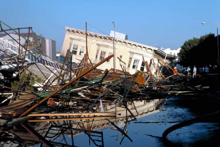 Ground view of collapsed building and burned area shown in photo 4, Beach and Divisadero, Marina District. [C.E. Meyer, U.S. Geological Survey]