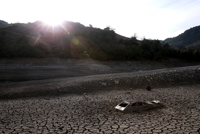 A car sits in dried and cracked earth of what was the bottom of the Almaden Reservoir on January 28, 2014 in San Jose, California. (Justin Sullivan/Getty Images)