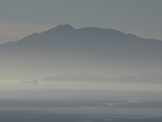 Looking west across San Pablo Bay, a tanker crosses in front of Mount Tamalpais, showing the poor air quality in December, 2013. (Craig Miller/KQED)