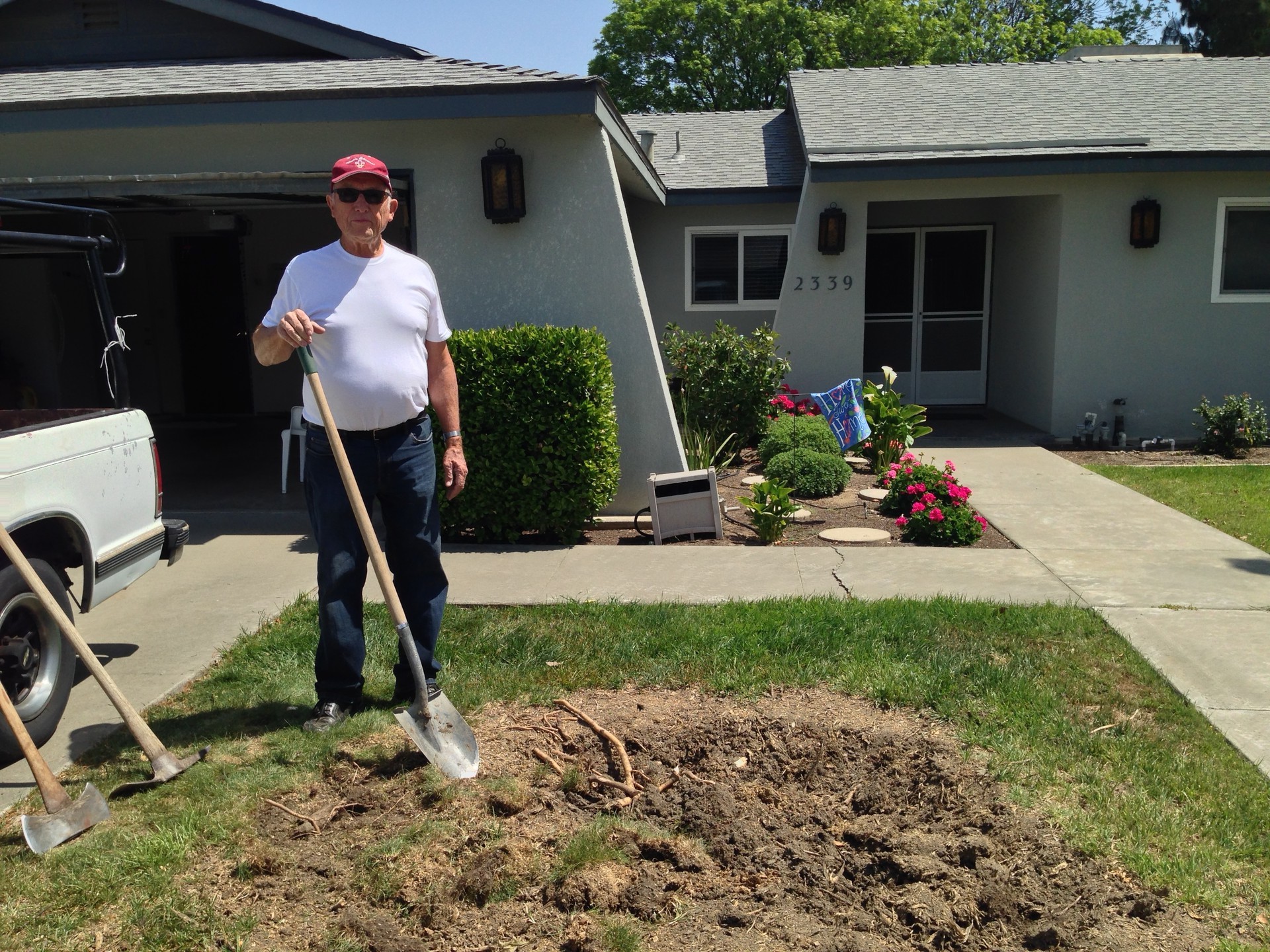 Tim Atkinson is tearing up his lawn in Hanford, which will save water but violate local landscape codes. (Sasha Khokha/KQED)
