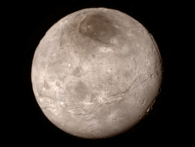 The first high-resolution photo of Pluto's moon Charon, showing deep canyons and cliffs. The dark area near the north pole, known to the scientists as 'Mordor', may just be a thin veneer of surface materials.