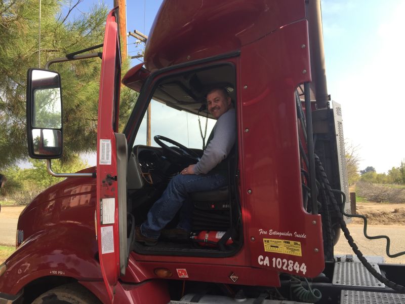 Trucker Shannon Doyle with his big rig. Every day, he drives 500 miles from Fresno to Los Angeles, hauling auto parts. 
