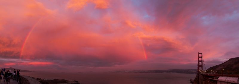 Sunset at the Golden Gate Bridge, a red rainbow appears.