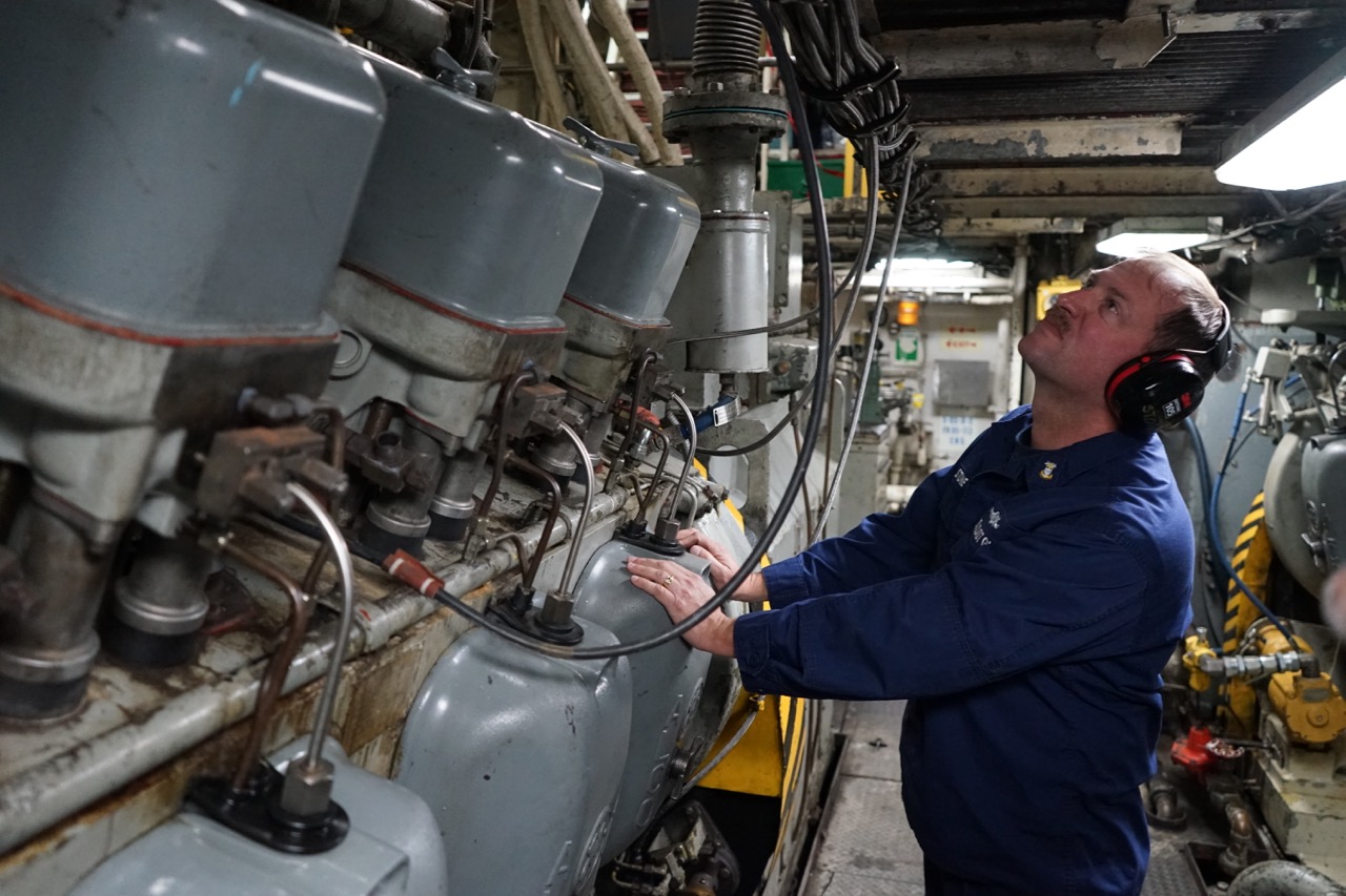 Master Chief Tom Stone inspects one of the ship's three service diesel generators, which provide "hotel" services like light and ventilation, as opposed to the six propulsion generators.