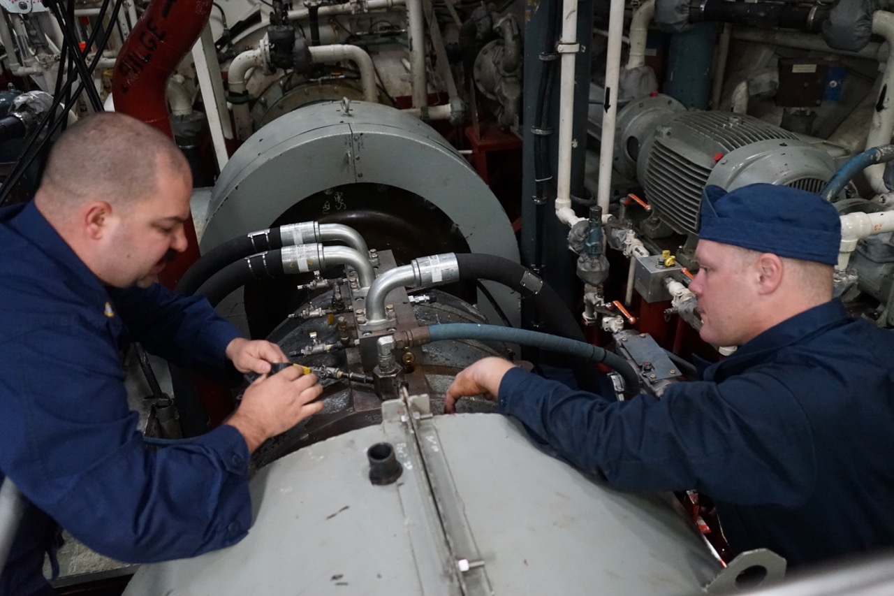 Chief Keith Hoeffer and Petty Officer Keith Bryan work on repairs to the propulsion system. Breakdowns are a way of life in the ice.