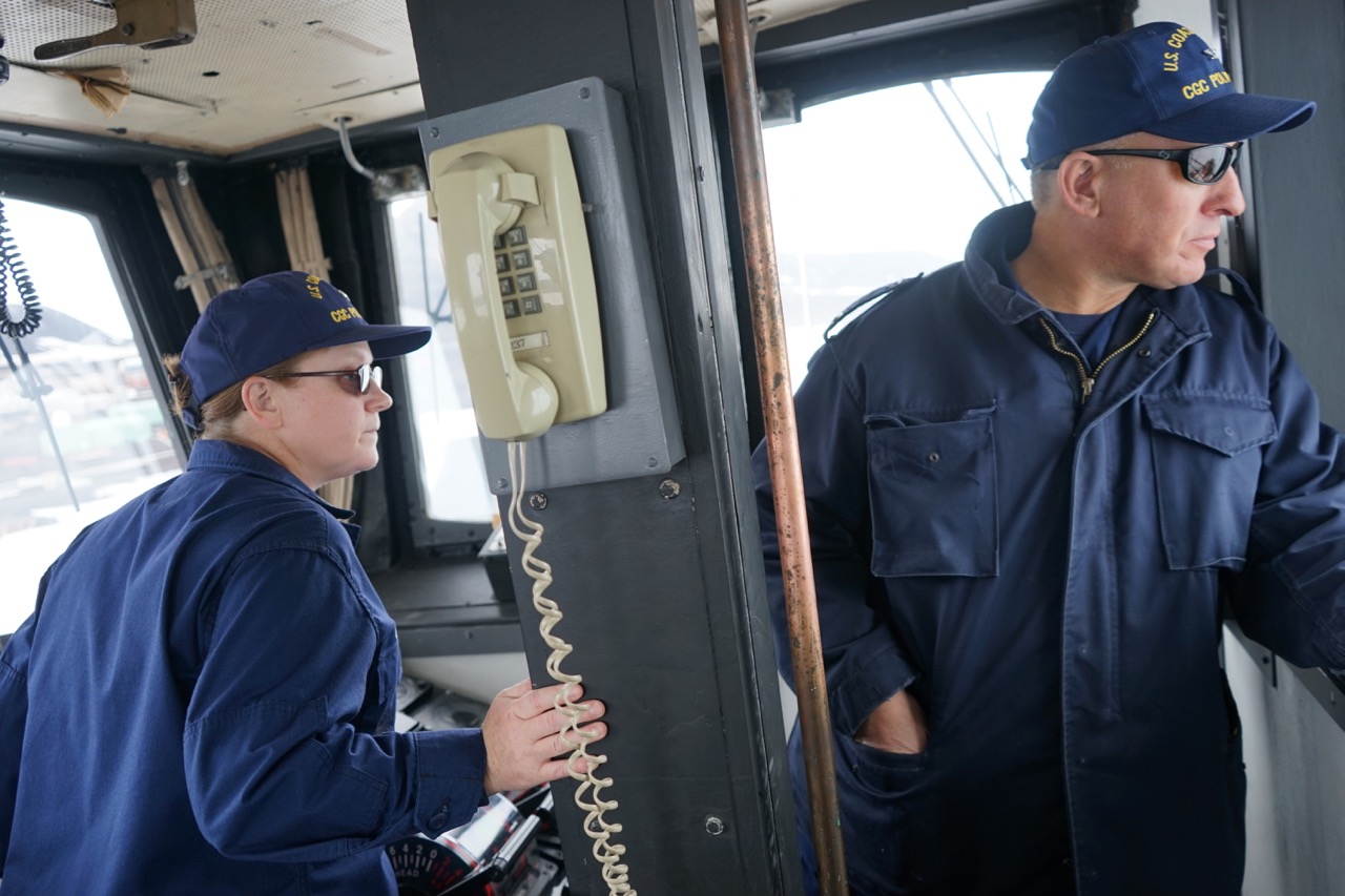 Executive Officer Cmdr. Mary Ellen Durley and Capt. Matt Walker look back at the turning basin as Walker breaks Polar Star into the pier at McMurdo Station.