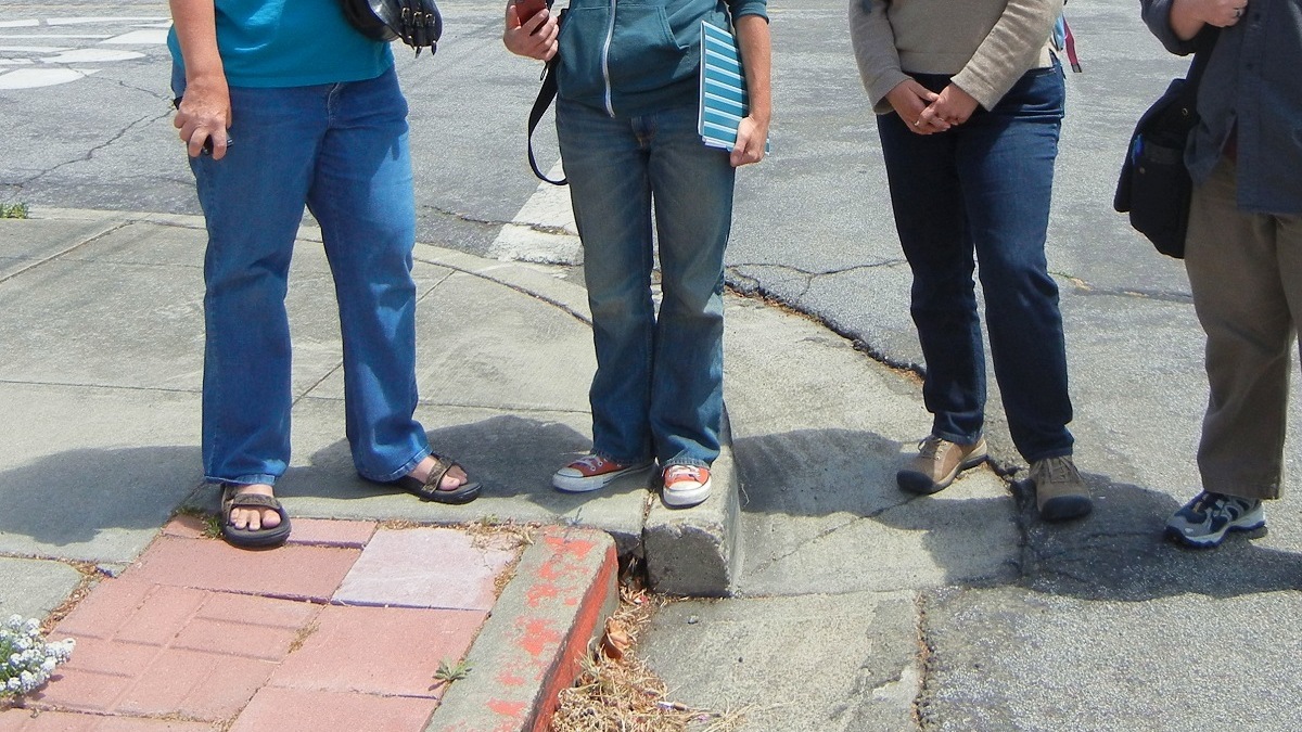 Geology enthusiasts gather at a (formerly) noteworthy curb in Hayward, Calif., in May 2012. The curb was once straight; the shifting Hayward fault pulled it apart.