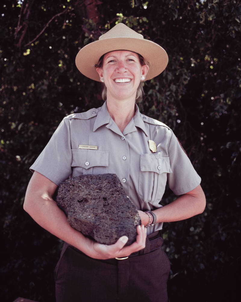 Park ranger Lindsay Smith poses with a chunk of volcanic rock in 2013.