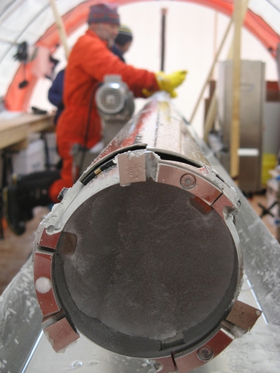 An ice core still sits inside a drill.