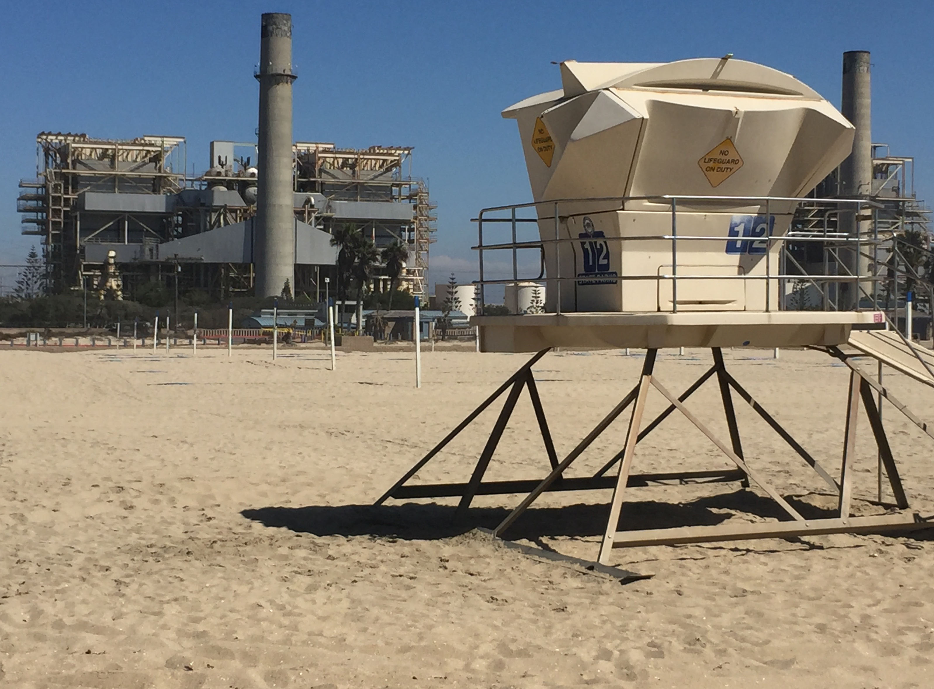 The proposed Huntington Beach desal plant would use the outflow pipe from the AES power plant (background) to deposit salt residue, known as brine, back into the ocean.