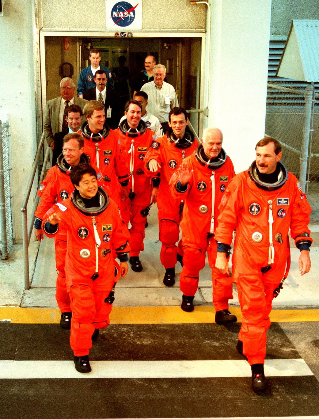 STS-95 crew members exit the Operations and Checkout Building where they suited up before leaving for Launch Pad 39-B on Oct. 9, 1998. John Glenn is second from the right. 