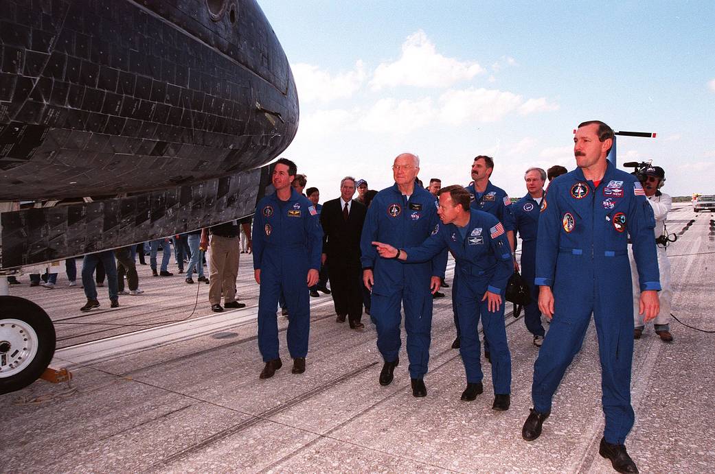 John Glenn (second from the left in the blue NASA suit) next to the orbiter Discovery on Nov. 8, 1998, that carried the STS-95 crew for nine days and 3.6 million miles.