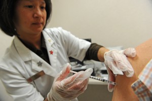 Pharmacist administers whooping cough vaccine. (Robyn Beck/AFP/Getty Images)
