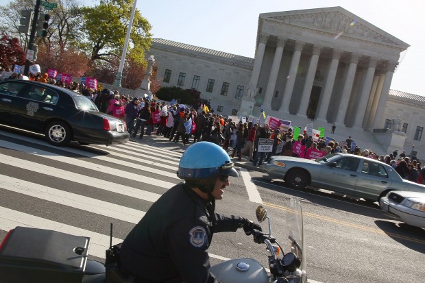 Protesters demonstrate in front of the Supreme Court on the second day of hearings about the constitutionality of the federal health care law. (Mark Wilson: Getty Images)