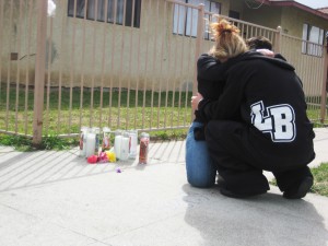 The mother and brother of murder victim Meldrick Melgoza embrace at the site where he was shot. (Photo: Anabell Romero)