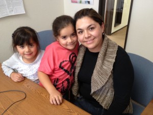 Maria Garibay worries her daughters won't be able to stay with their current doctors when they switch from Healthy Families to Medi-Cal next year.(Mina Kim: KQED)