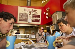 Cyrus Stenstedt, second from right, a freshman at Berkeley High School, drinks soda while lunching off-campus at Top Dog near the school. (Noah Berger/Center for Investigative Reporting)