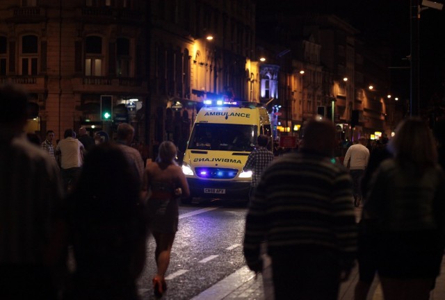 An ambulance makes its way through revelers in Cardiff city center in Wales in 2010. New measures in the city have reduced injuries caused by violence.