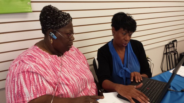Onita Sanders, a certified application counselor at the Southeastern Virginia Health System, tries to helps Brenda Harrell enroll in health coverage at Enrollfest in Hampton, Va. (Jenny Gold/KHN)