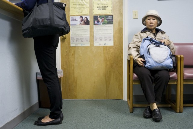 A woman waits to see Dr. Gustin Ho at his office in San Francisco's Chinatown. Ho says 99 percent of his current patients are ethnically Chinese, but that for CCHP, "diversity is the way to go." (Marcus Teply/KQED)