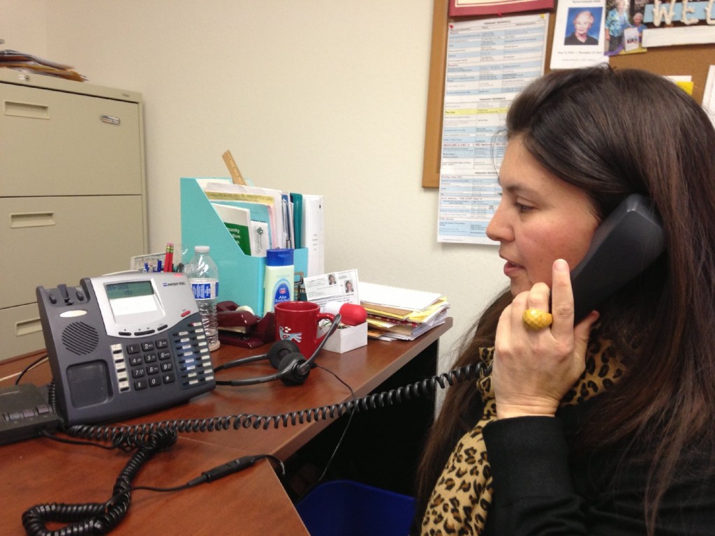 Christina Kahn, manager of the San Mateo Health Insurance Counseling and Advocacy Program, returns phone calls to local seniors.