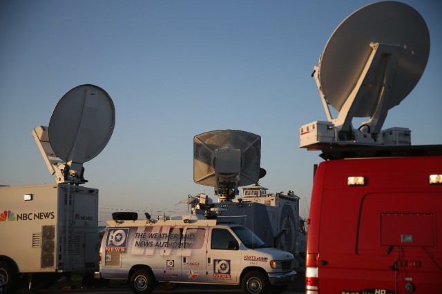 Television news live trucks at the front gate of Fort Hood, Texas. (Joe Raedle/Getty Images)