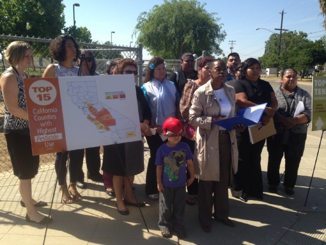 Central Valley farmworkers and environmentalists protest pesticide spraying on farms near schools, from outside an elementary school in West Fresno at risk.  (Sasha Khokha/KQED)