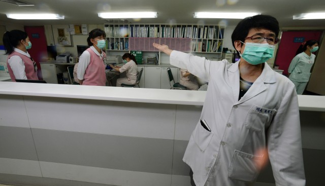 A nurse introduces the front desk for the negative pressure isolation rooms section, which will be used to treat potential H7N9 avian influenza patients, at a Taipei hospital on April 6, 2013, just after the H7N9 virus emerged on China's mainland. (Sam Yeh/AFP/Getty Images)