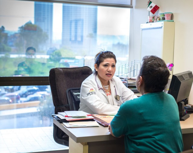 Dr. Cecilia Espinoza meets with her patient Irma Montalvo. Montalvo, a U.S. citizen, prefers to travel to Mexico for health care, even though she signed up for a health plan through Covered California (Heidi de Marco/KHN).