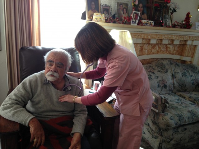 Sutter nurse Aileen Capuyan listens to Bob Martinez’s lungs. (April Dembosky/KQED)