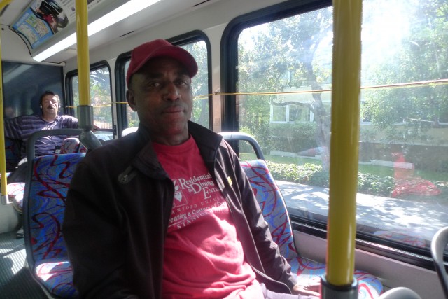 Leaburn Alexander works two jobs and does not have health insurance. Here, he is on the start of his 3-hour commute home from the job he works as an overnight hotel janitor. (Lisa Morehouse/KQED)