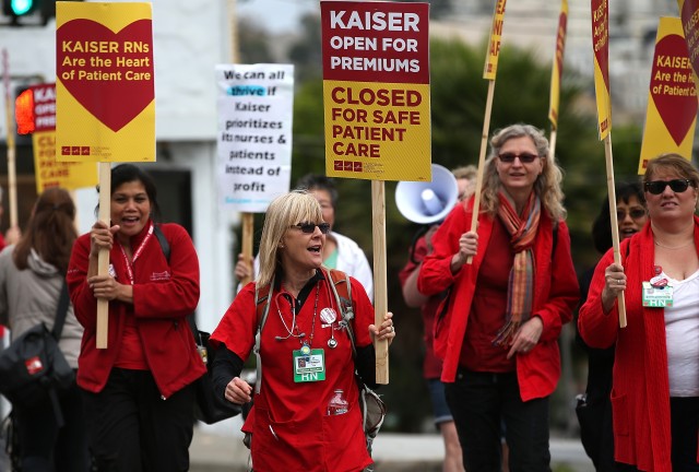 Nurses carry signs as they strike outside of Kaiser Permanente hospital in San Francisco last week. (Justin Sullivan/Getty Images)