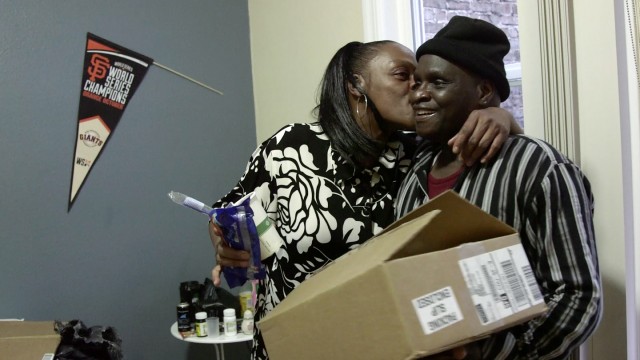 Clarence Cook moves into his brand new apartment at 250 Kearny, with the help of his girlfriend Lynette Baldwin. (Adam Grossberg/KQED)