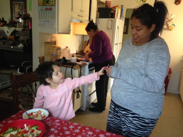 Norma Acker hangs out in the kitchen with her mom and her daughter. (Alice Daniel/KQED)