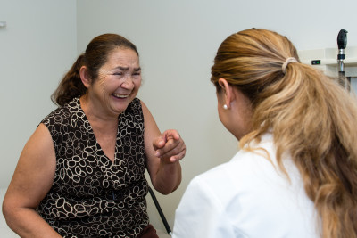 Patient Maria Sanchez, 54, shares a light moment with her doctor, second year resident, Jennifer Vargas. 
