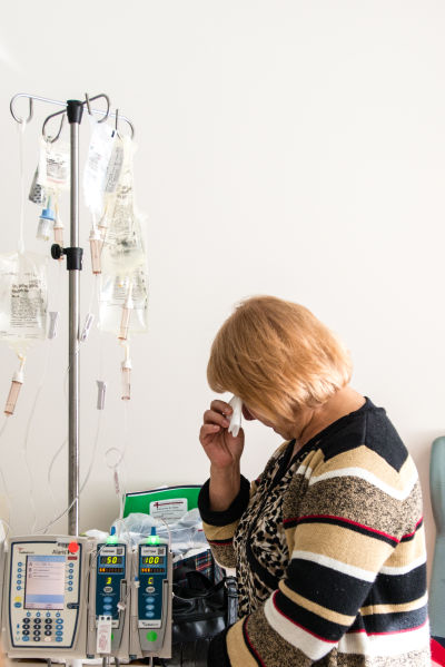 Jose Garcia Flores’ wife stands quietly at her husband’s bedside.