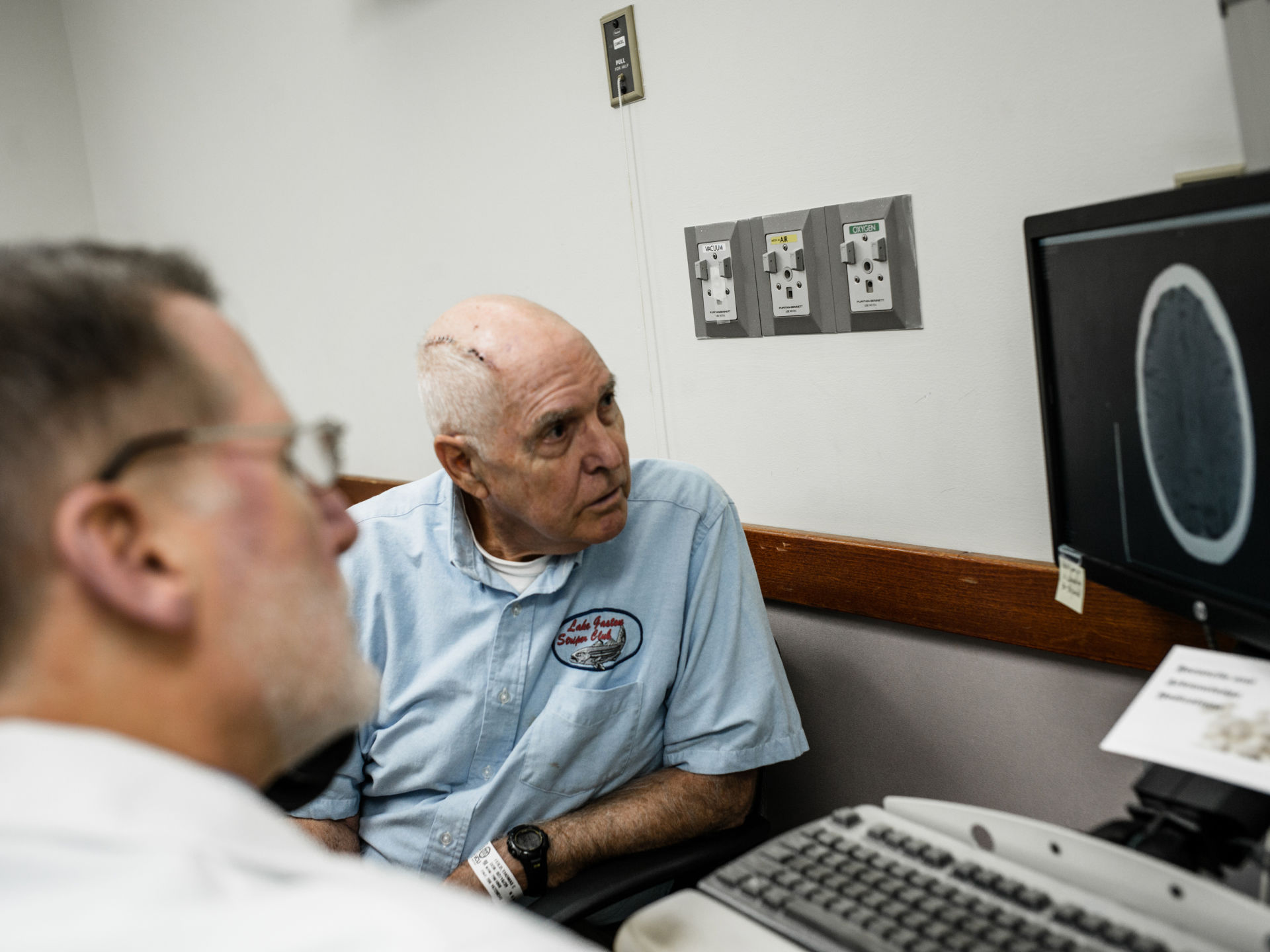 Tom Feild looks at a brain scan with his doctor at Virginia Commonwealth University Medical Center in Richmond, Va. Feild had brain surgery after experiencing a low-grade headache that wouldn't go away and difficulty driving.