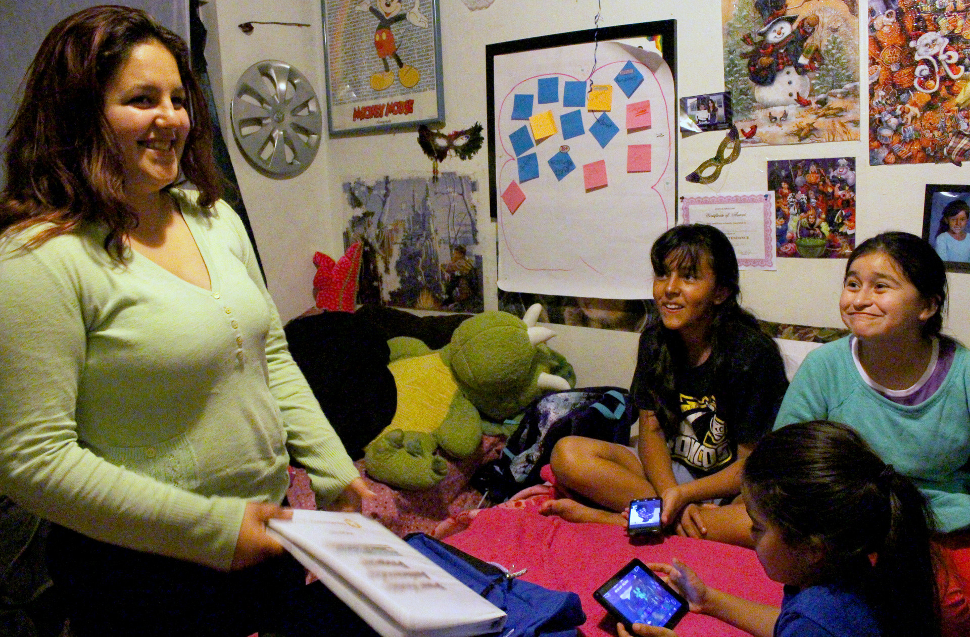Maryjane Davis in her bedroom with sister Ricci, 12, friend Mary Jane Rodriguez, 11, and sister Lily, 8. Maryjane trained to become a peer health ambassador with a local non-profit to help friends at school learn about how to prevent STDs and unplanned pregnancies.