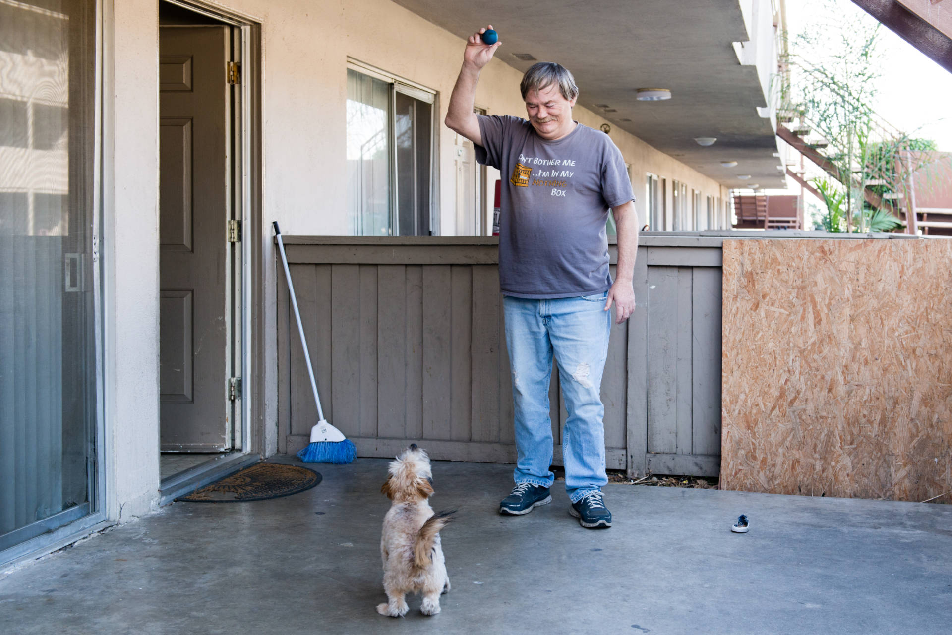 Donald Meade plays with his puppy, Scrappy, at his new apartment in Fullerton, Calif.