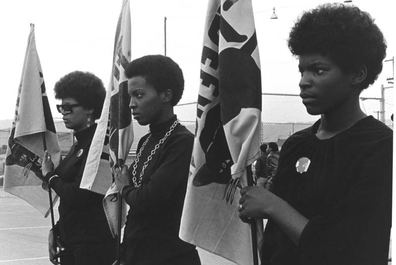 Women drilling with Panther flags.