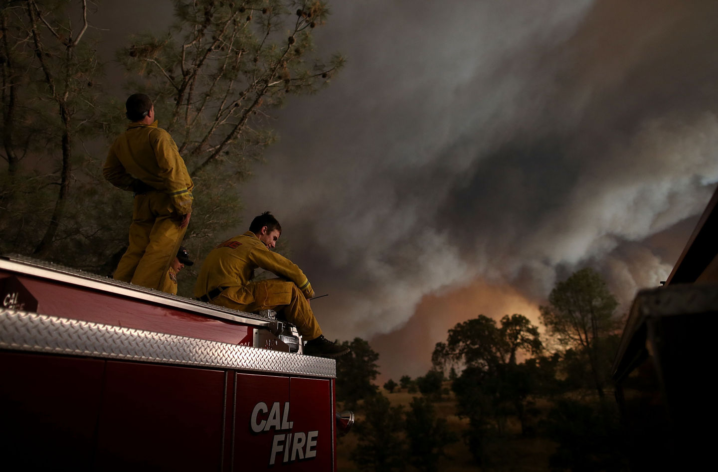Members of a Cal Fire crew take a break Saturday as the Rocky Fire continued to spread through the countryside east of Clear Lake.  Justin Sullivan/Getty Images
