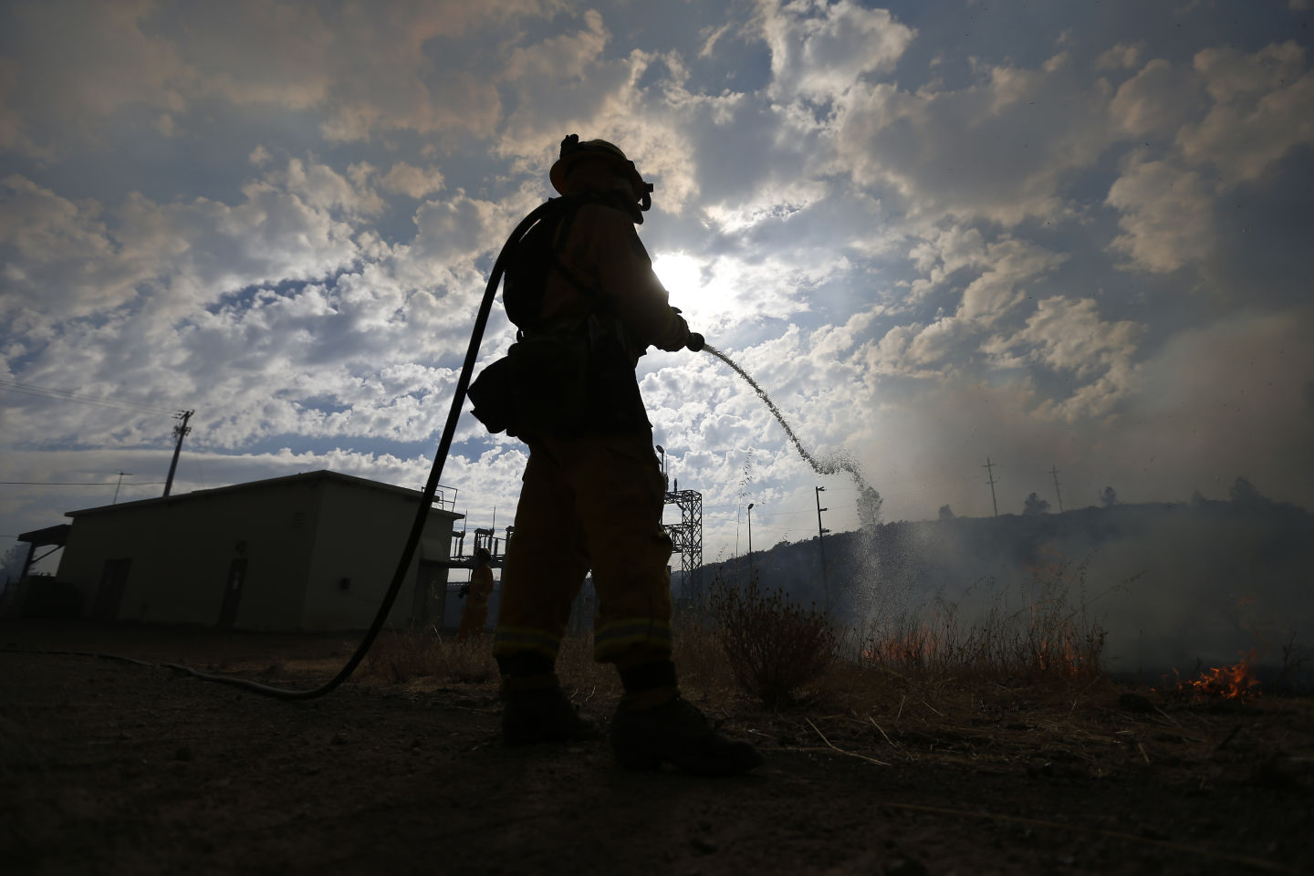 Firefighter douses a backfire set Tuesday  to try to limit the spread of the Jerusalem Fire in Lake County.  Stephen Lam/Getty Images