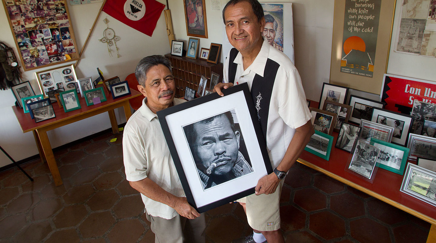 At the Paulo Agbayani Village west of Delano, Roger Gadiano (L) and Alex Edillor hold a photo of grape strike leader Larry Itliong, whom they respectfully refer to as "The Man." Henry A. Barrios/FERN