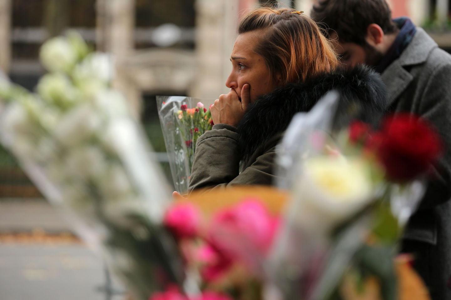  A woman reacts afetr placing flowers near the scene of yesterday's  Bataclan Theatre terrorist attack.  Christopher Furlong/Getty Images)