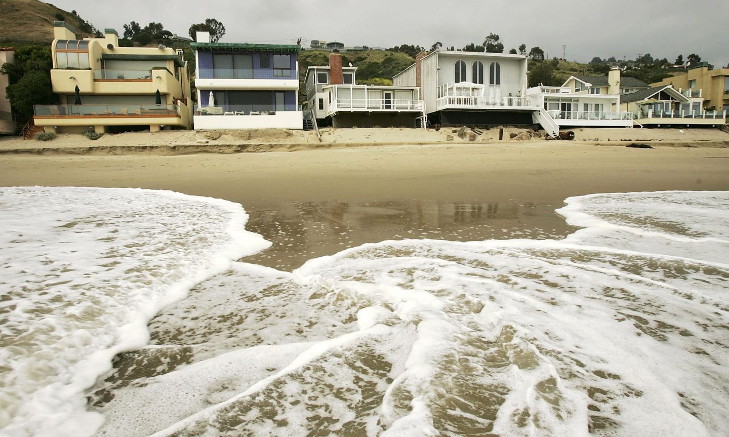 Luxurious beach houses crowd the shoreline hiding Carbon Beach in Malibu. A lengthy legal battle over public access to the beach culminated in 2005, with music producer David Geffen allowing a public pathway across his property in exchange for permits from the Coastal Commission to begin building a Cape Cod-style compound across multiple lots.  David McNew/Getty Images