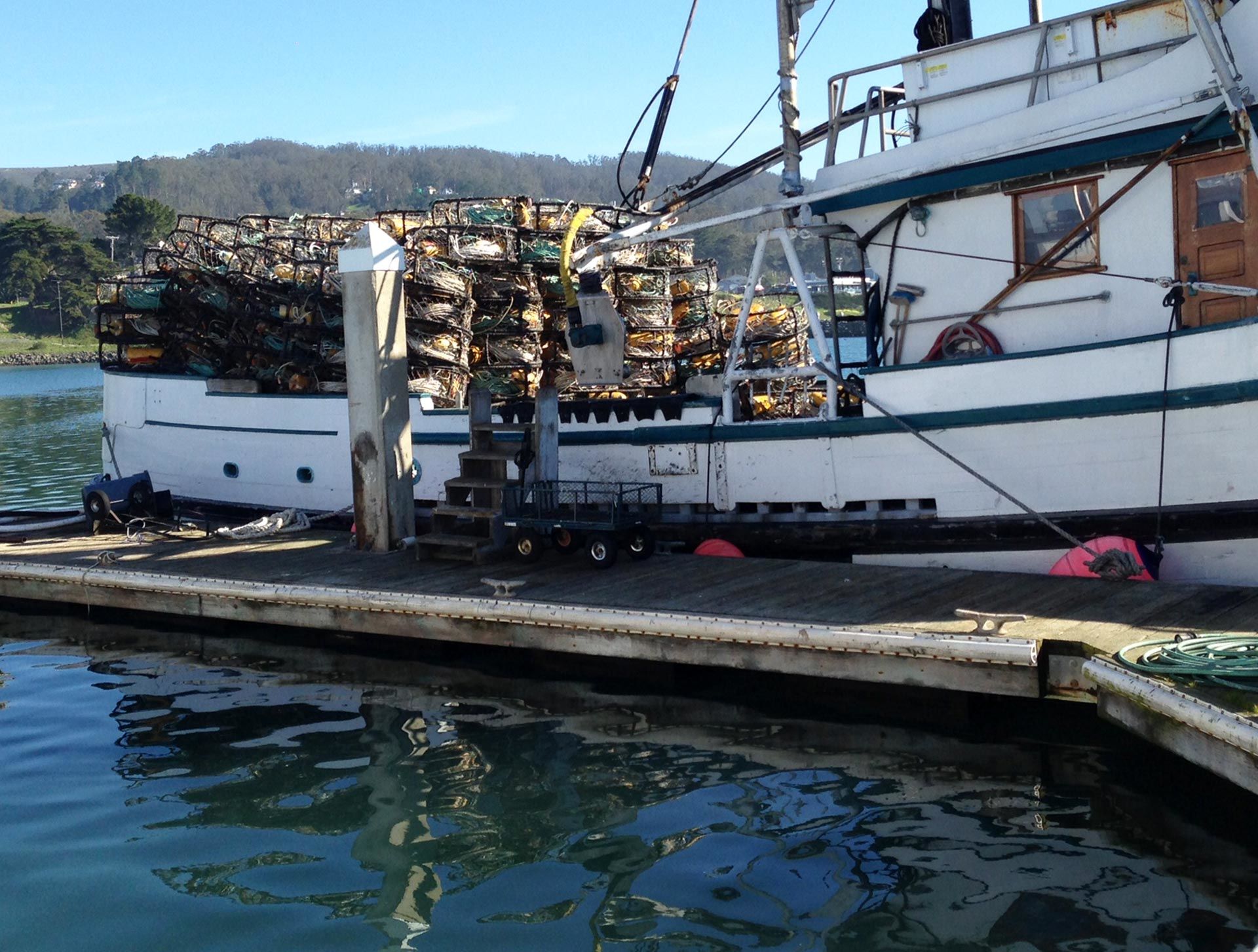 Crab pots sit unused on a fishing boat in Half Moon Bay harbor. Adia White/KQED