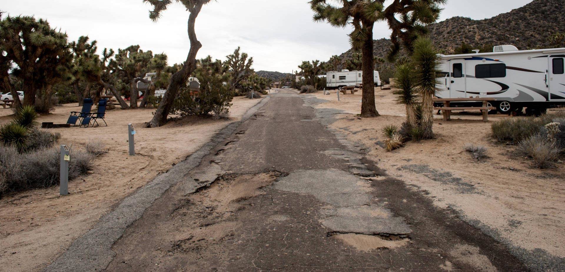 Flooding and the combined traffic of thousands of cars, trucks and RVs have torn up the roads at Joshua Tree National Park's Black Rock Canyon Campground. The majority of the park's $60 million maintenance backlog is for roads like this. Nathan Rott/NPR