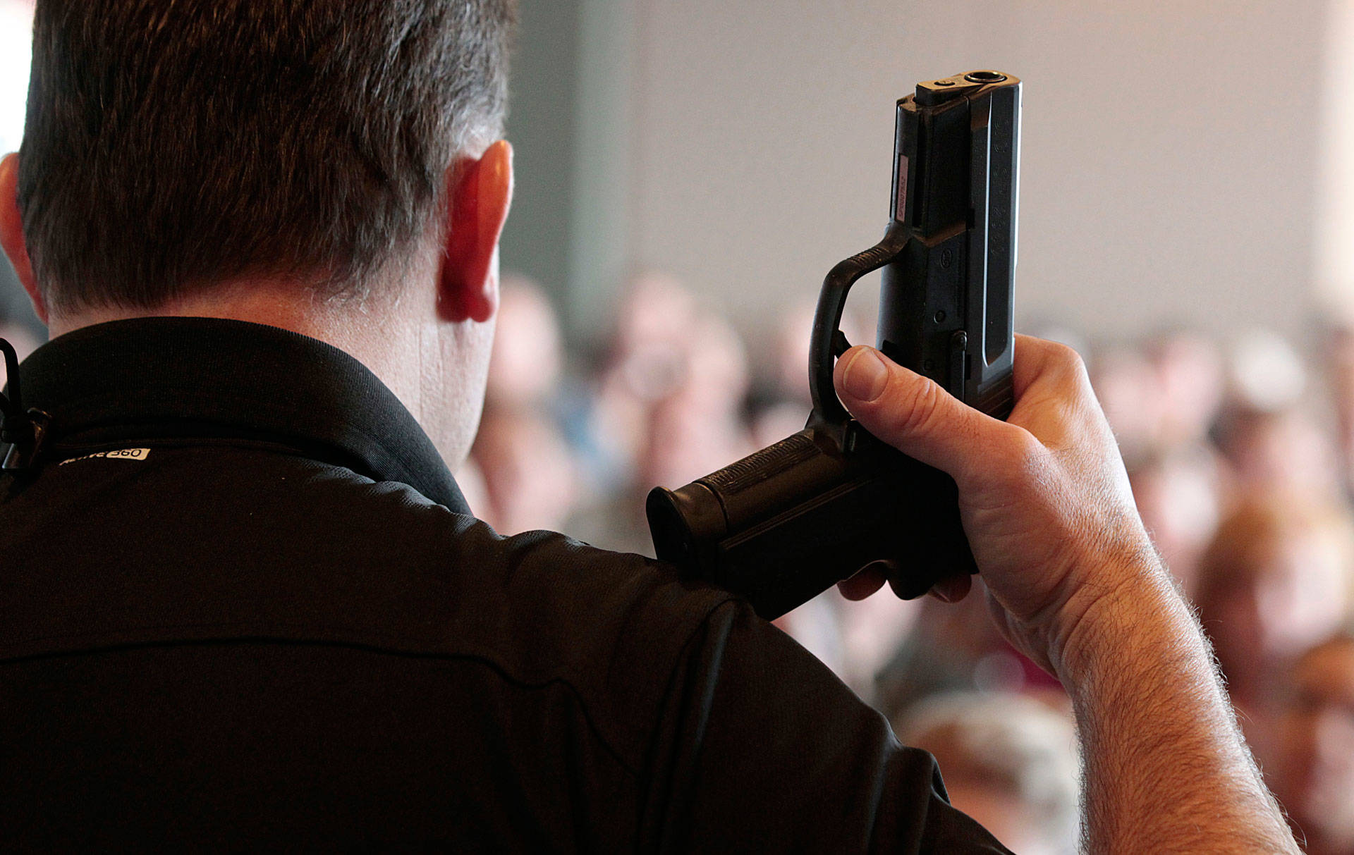 A firearm instructor holds a handgun up as he teaches a concealed-weapons training class to teachers in Utah. George Frey/Getty Images