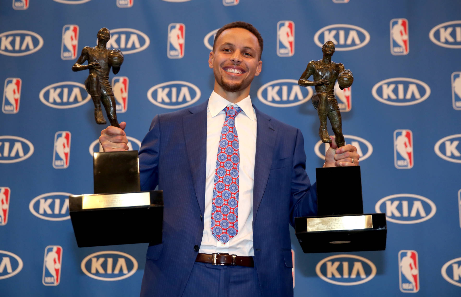 Stephen Curry poses with his back-to-back NBA Most Valuable Player Awards following a press conference. Ezra Shaw/Getty Images